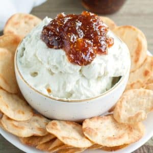 Bowl of whipped goat cheese topped with fig jam.