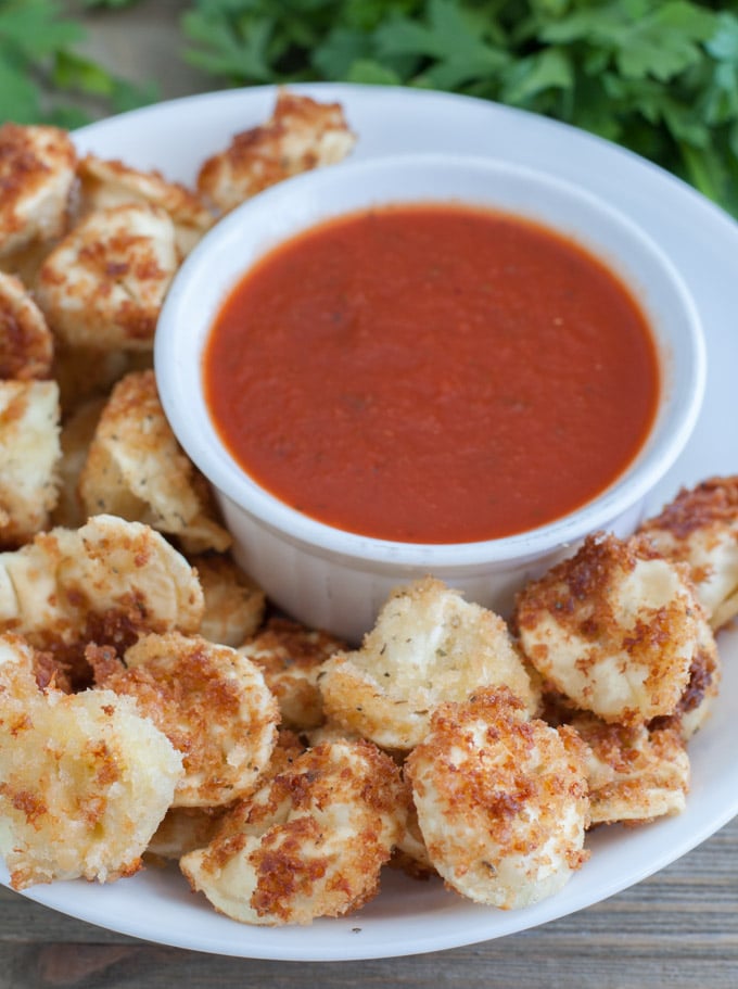 fried tortellini on a plate with marinara sauce