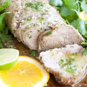 Pork tenderloin with slice of orange and lime.