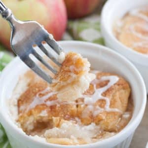 Bowl with apple crisp and apples in background.