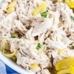 Bowl with shredded chicken and banana peppers.