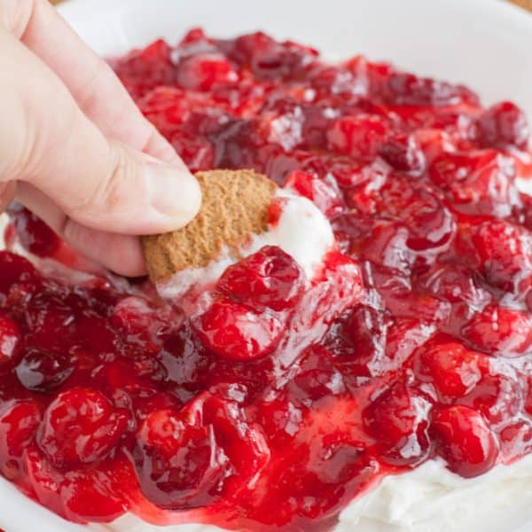 Cookie dipped in cherry dip.