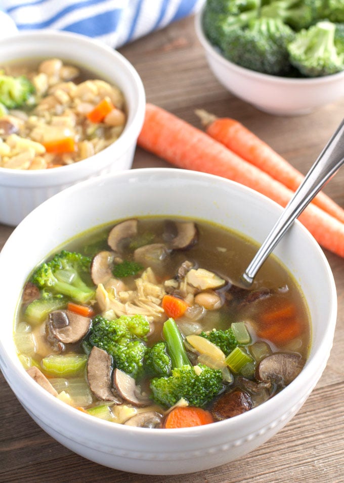 detox chicken soup in a bowl with carrots and broccoli