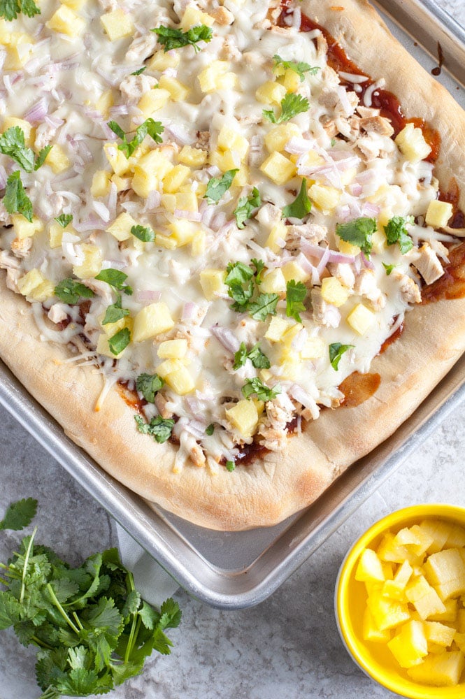 sheet pan pizza with pineapple in a bowl