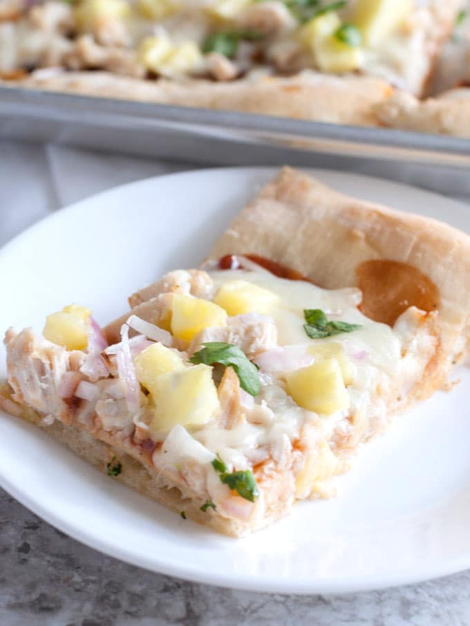 piece of bbq chicken pizza on a plate