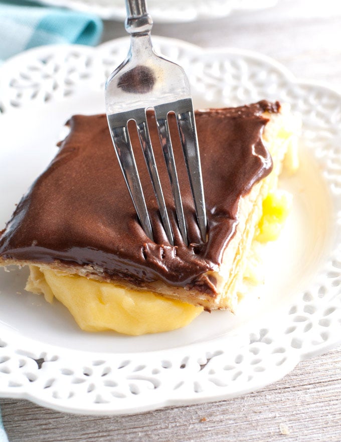 chocolate eclair cake on a white plate with a fork