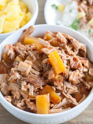 BBQ shredded pork with pineapple tidbits in a bowl.