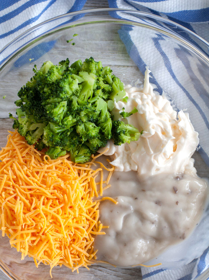 broccoli, cheese, mayonnaise and cream of mushroom in a bowl