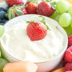 Bowl with creamy fruit dip surrounded by fruit.
