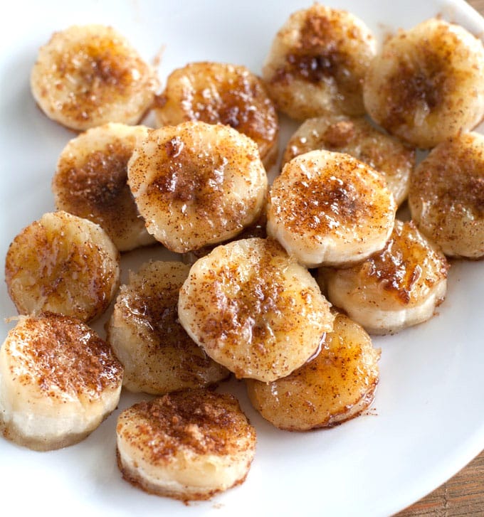 Bananas with cinnamon and sugar on a white plate