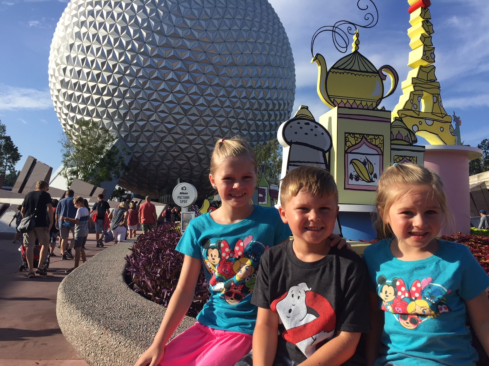 Kids sitting in Disney Epcot.