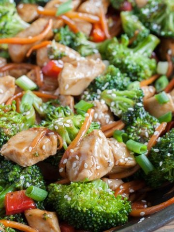 Cooked chicken, broccoli and carrots in a skillet.