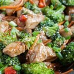 Cooked chicken, broccoli and carrots in a skillet.