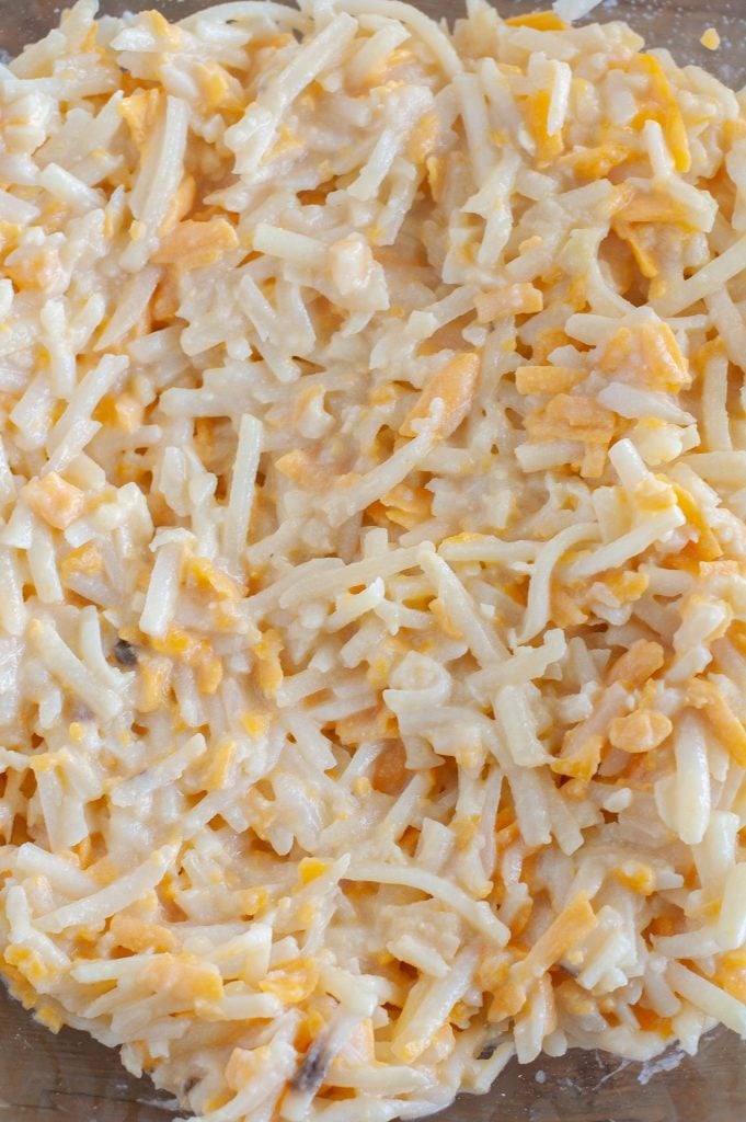 shredded hashbrowns with shredded cheese in a bowl