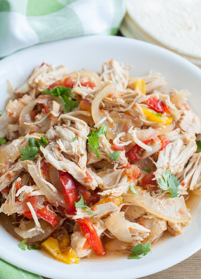 Bowl with shredded chicken, onions and peppers. 