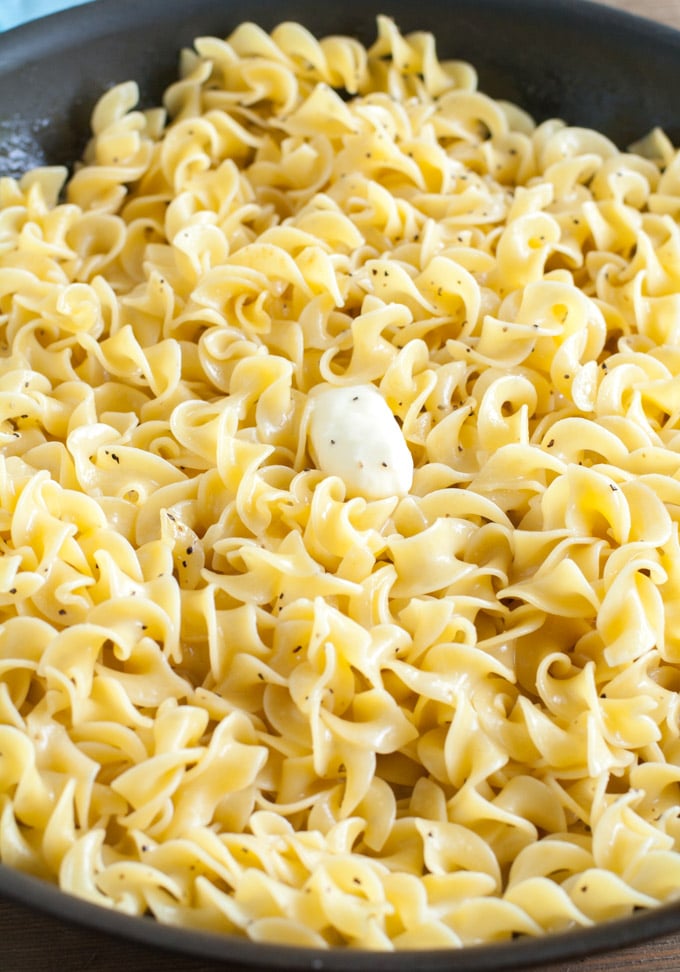 Buttered Noodles egg noodles with a pat of butter in a skillet