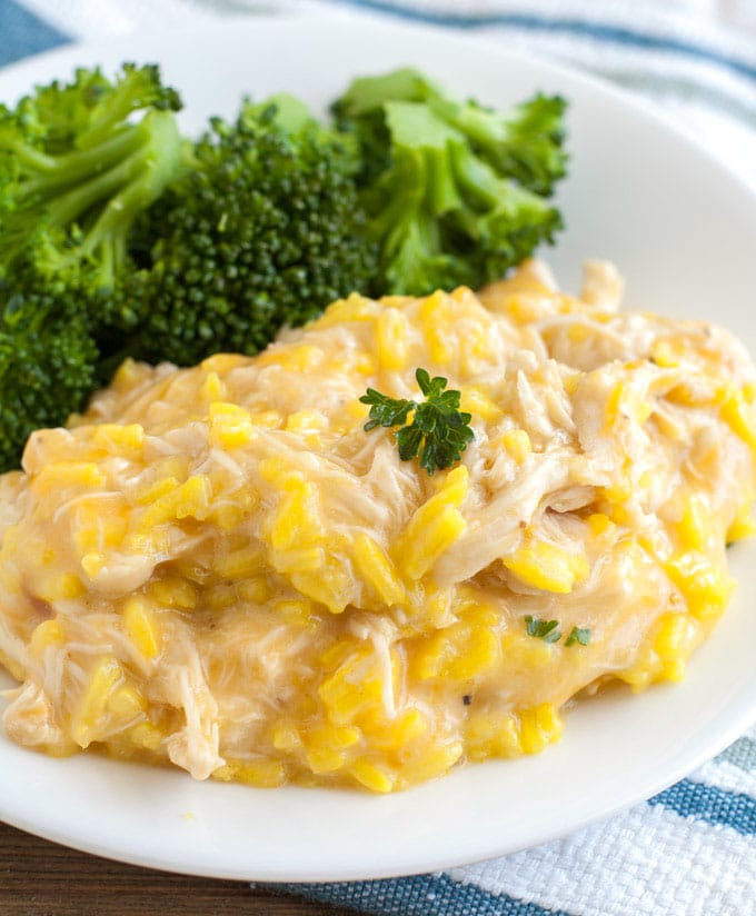 chicken and rice on a plate with broccoli