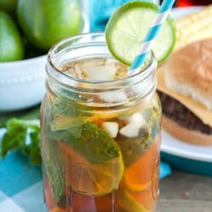 Mason jar with tea, mint and lime slice.