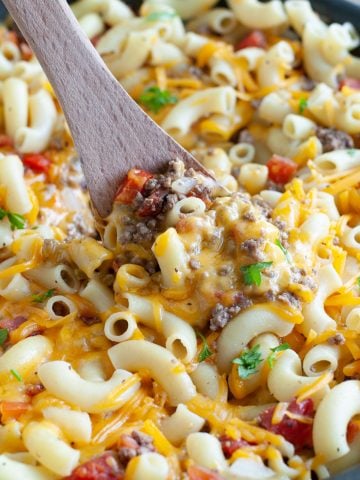 Skillet with macaroni noodles, ground beef and melted cheese.