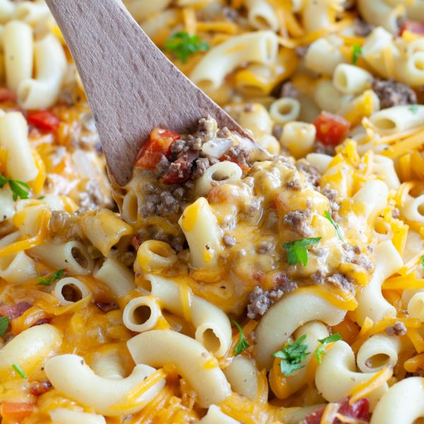 Skillet with macaroni noodles, ground beef and melted cheese.