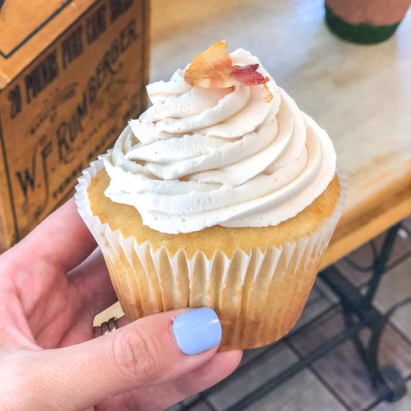 Hand holding cupcake.