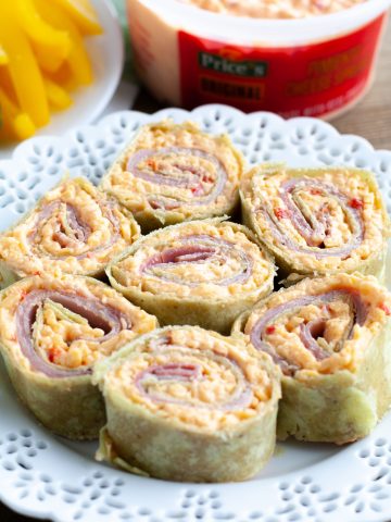 Plate with ham and cheese roll ups.