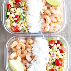 Container with shrimp, rice and corn salsa.