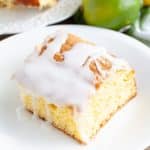 Piece of cake with icing, lemon and limes.