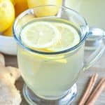 Glass coffee cup with tea and lemon.