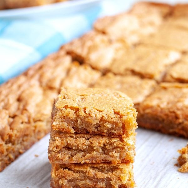 Blondies stacked on table.
