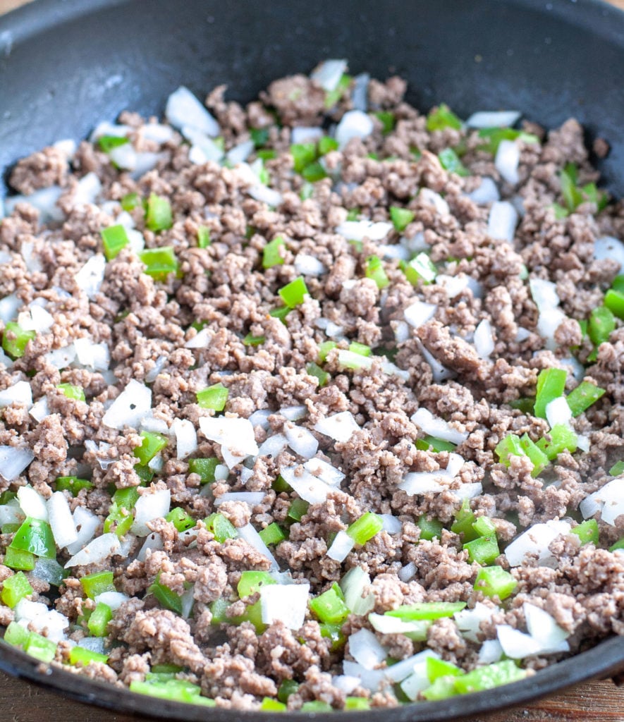 Skillet with ground beef, onions and peppers. 