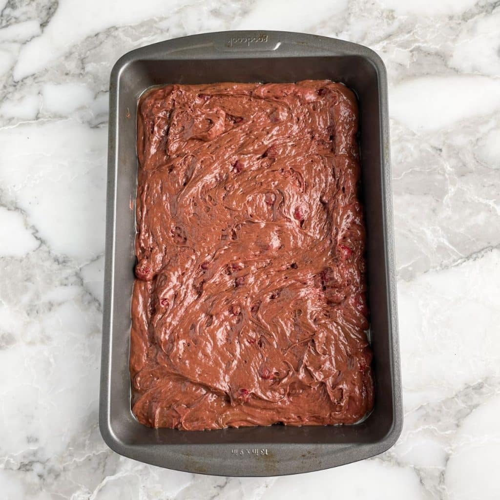 Chocolate cake batter in a rectangular pan.