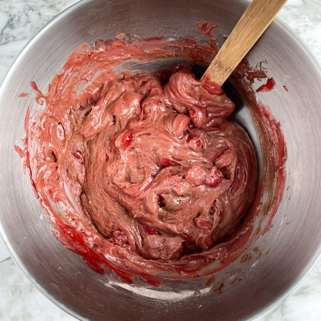 Mixing bowl with cherry pie filling and cake batter.