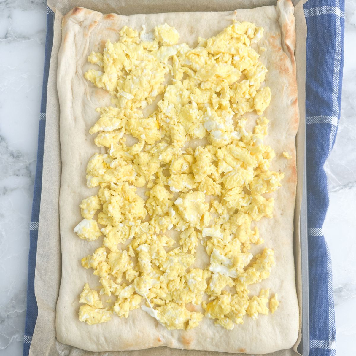 Pizza dough with scrambled eggs.