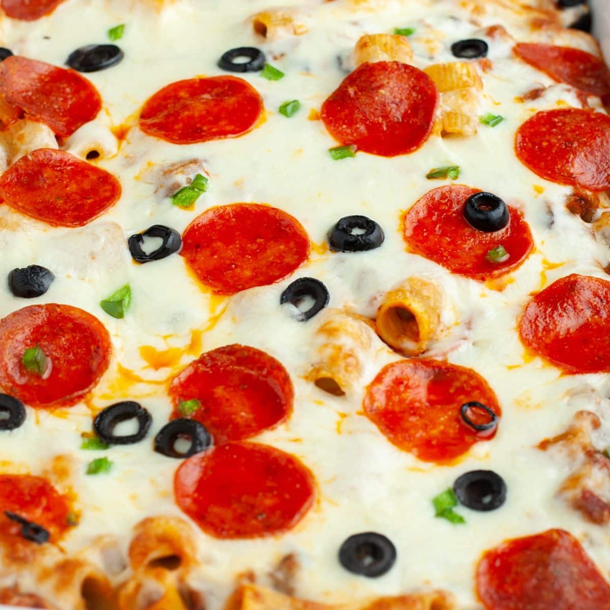 Pizza casserole with pepperoni, olives, and peppers. 