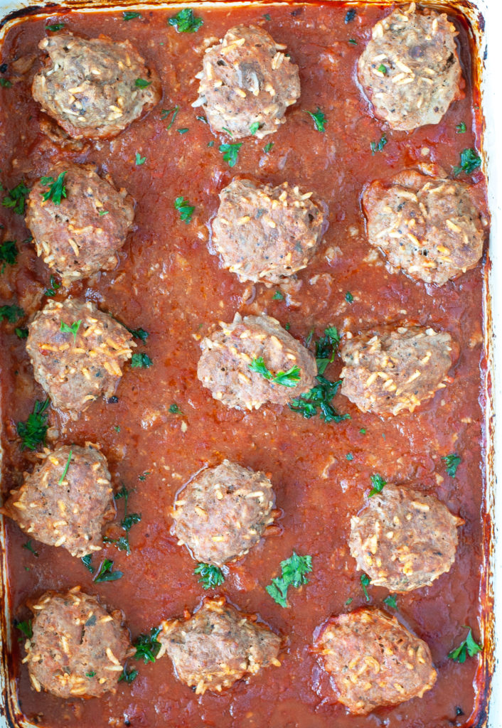 Baked meatballs out of the oven in casserole dish. 