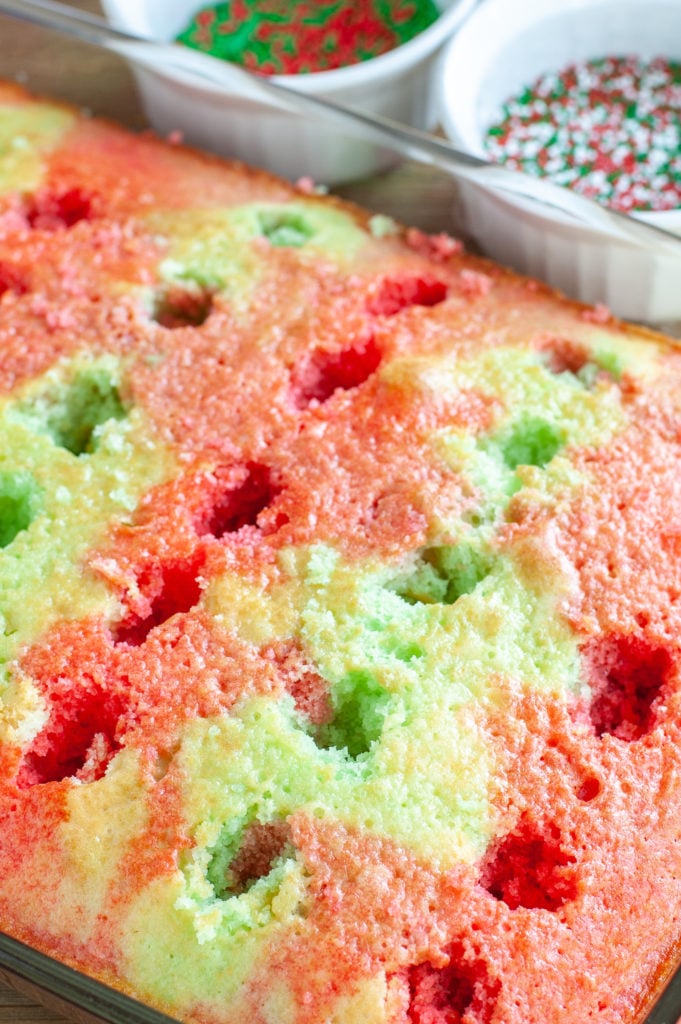 Jello cake in baking dish with holes and jello