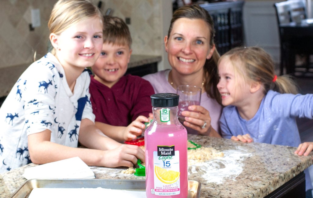 Women, boy and two girls with bottle of lemonade. 