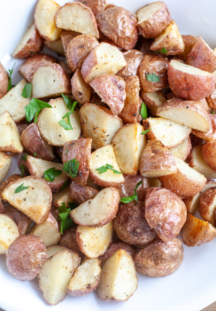 Bowl of roasted red potatoes with herbs