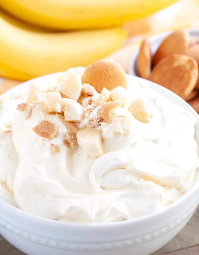 Banana Pudding Dip in a bowl with crushed cookies and diced bananas