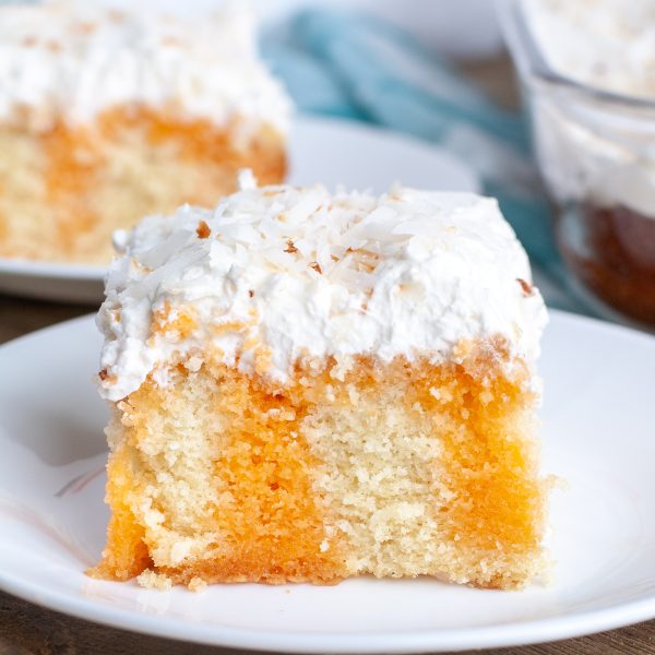 Orange cake on plate with frosting.