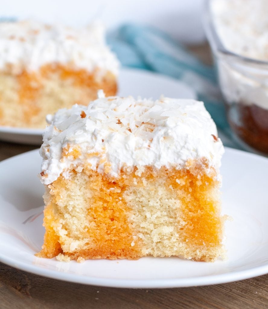 Piece of orange poke cake on a plate