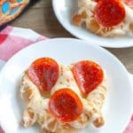 Plate with soft pretzel and pepperoni.