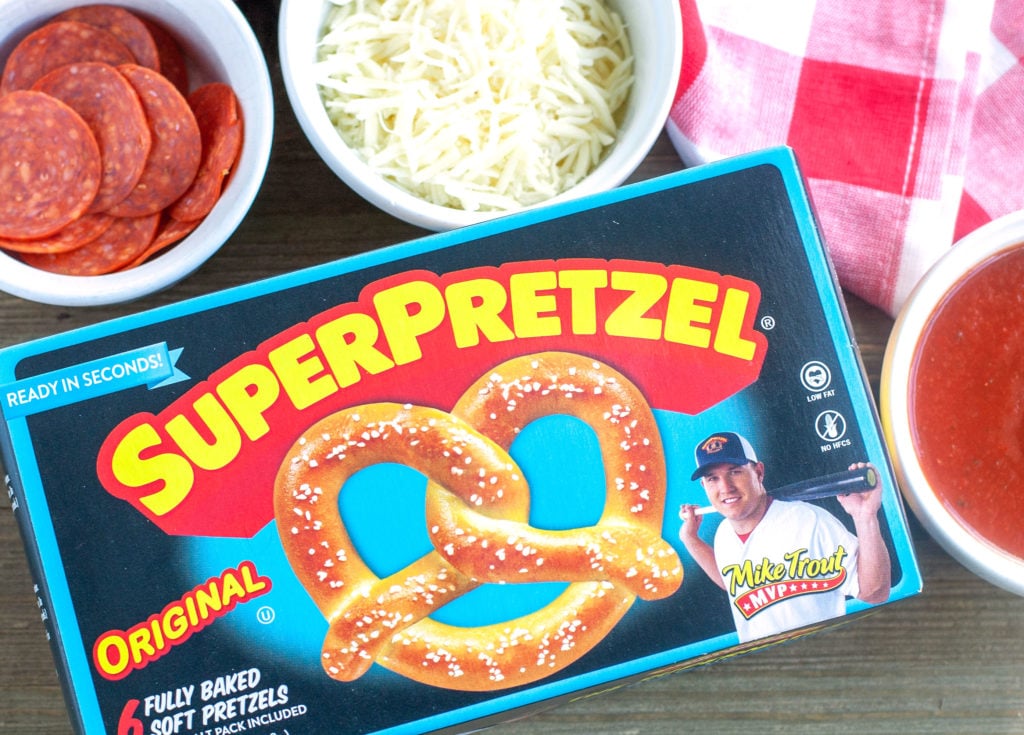 Box of Super Pretzels on table with bowl of pepperoni and cheese. 