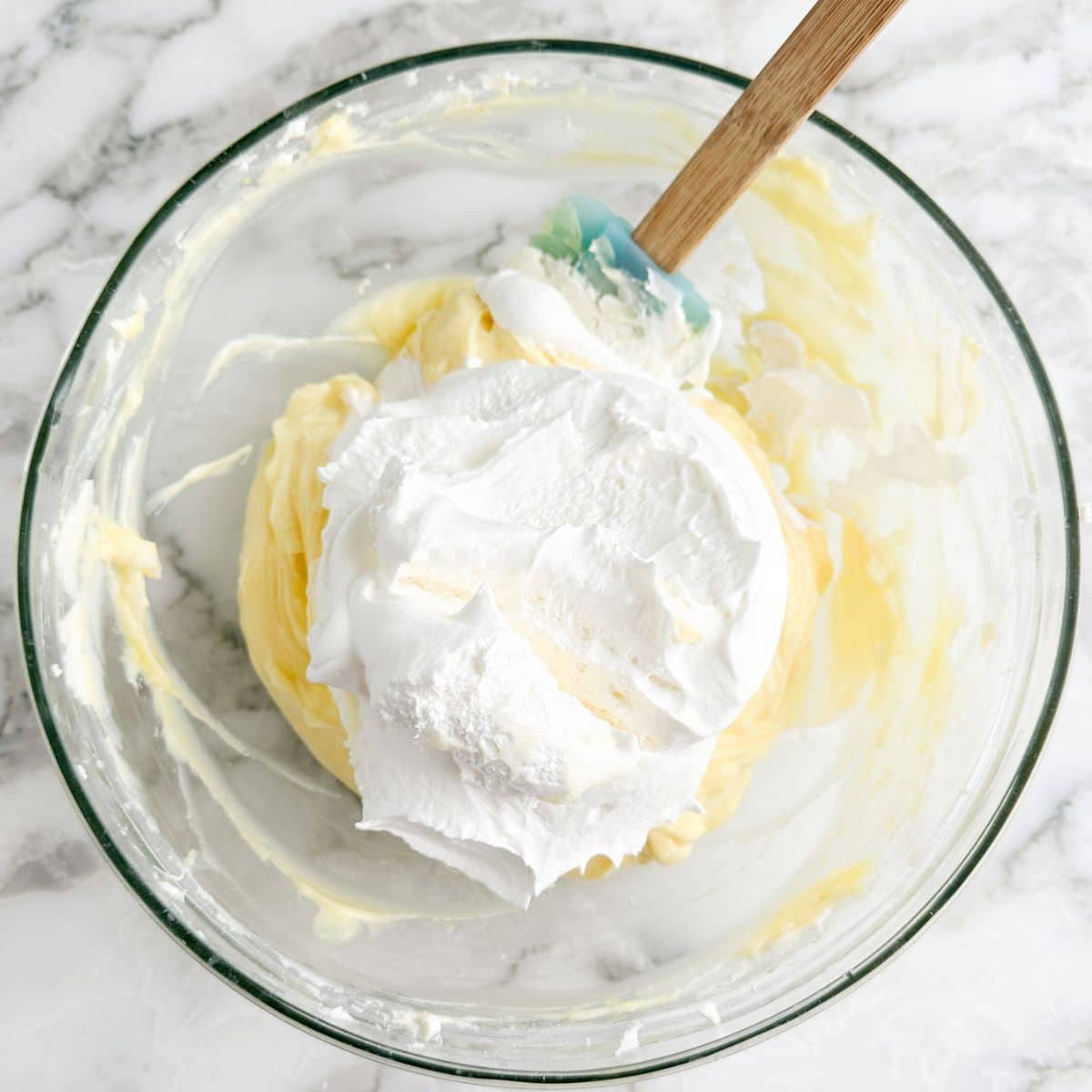 Bowl of vanilla pudding and whipped topping. 