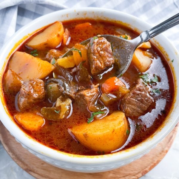 Bowl of beef stew with a spoon.