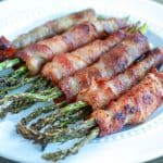 Bacon wrapped asparagus on plate.