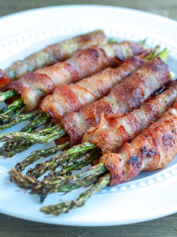 Bacon wrapped asparagus on plate.