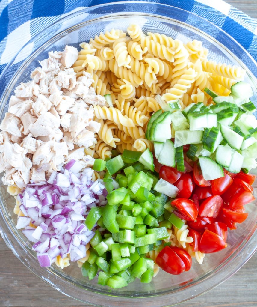Large Bowl with Pasta, diced chicken, red onion, green pepper, cucumber and diced tomatoes.