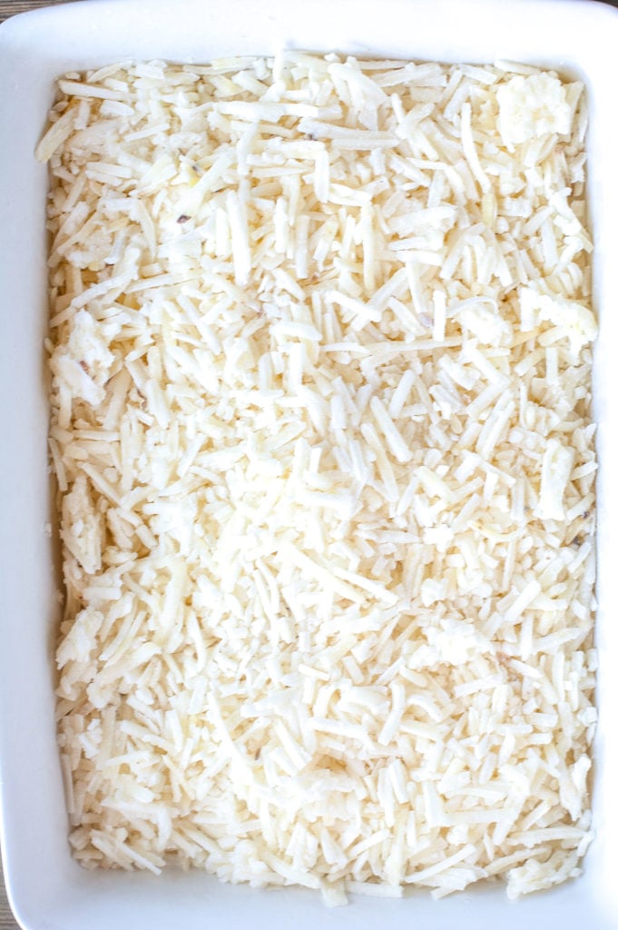 Frozen shredded hash browns in a casserole dish